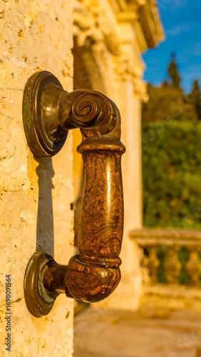 Ornate door handle on a stone wall