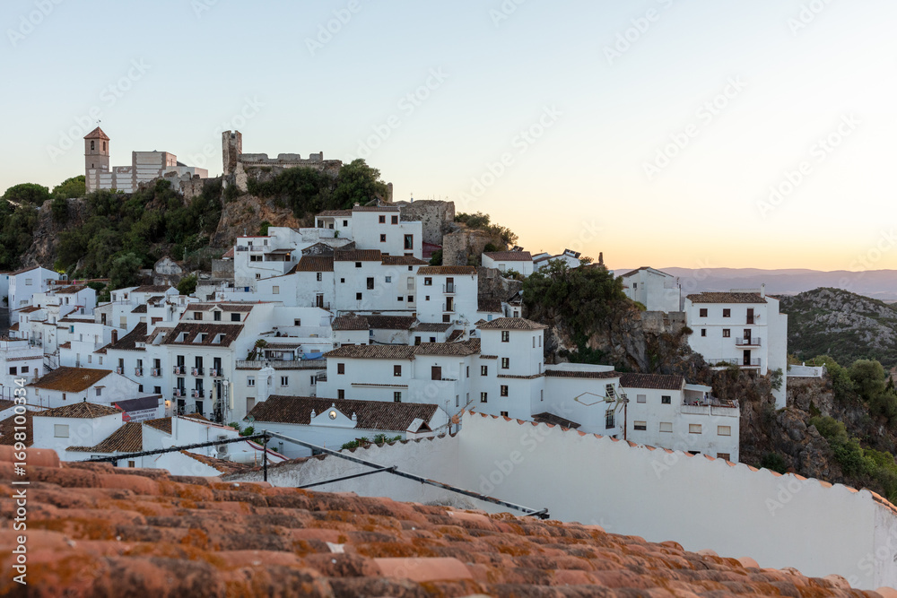Fototapeta premium Casares, Andalusia, Spain. 5 September 2025. Whitewashed village and castle hill at sunset.