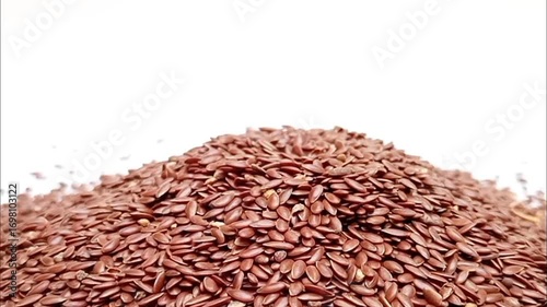 Pile of organic Flaxseeds rotating on a white background, closeup, Dry Linum usitatissimum