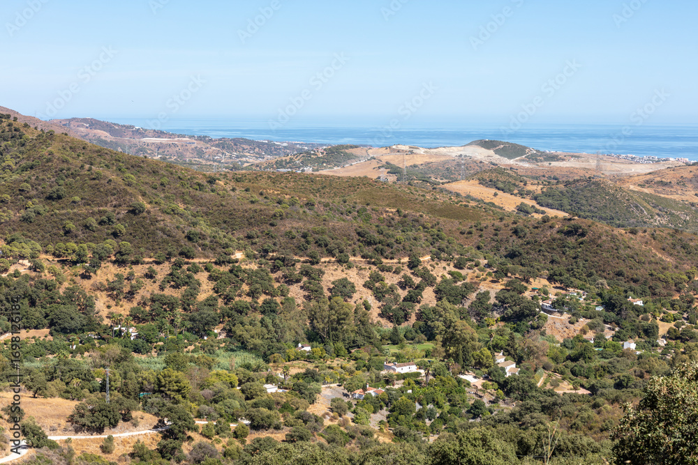 Obraz premium Mountain landscape near Casares with green hills and blue sky. Casares, Andalusia Spain. 5 September 2025.