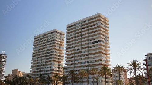 Beachfront towers rising over the palms at Playa de San Juan, Alicante, Spain