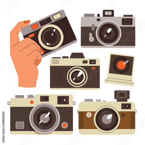 Hand holding a vintage camera surrounded by other retro cameras Keywords: camera, vintage, retro