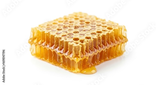 Golden honeycomb dripping with sweet, natural honey, isolated on a white background.