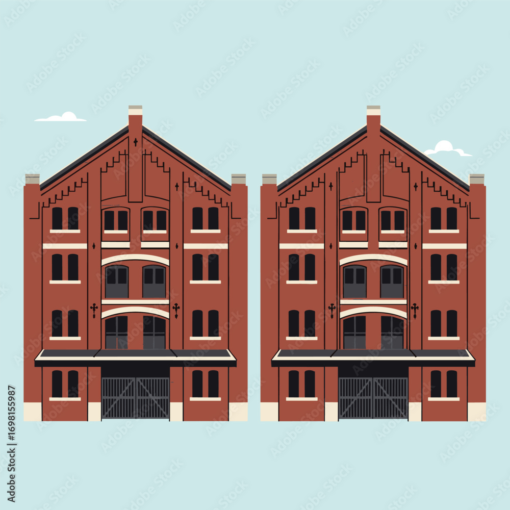 Fototapeta premium Two identical brick warehouse buildings with peaked roofs and large bay doors under a clear blue sky with fluffy clouds