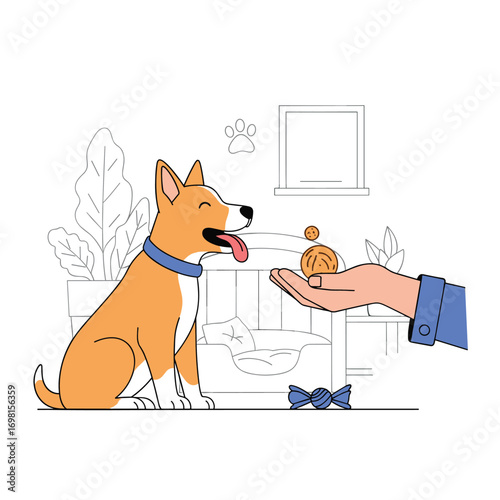 Owner giving a tasty treat to their happy dog during a training session indoors