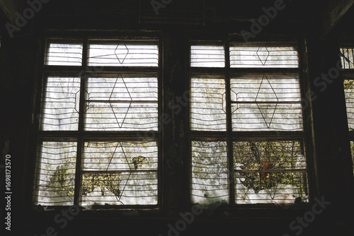 Old abandoned building. Old windows.Horror concept. window silhouette. Scary bars on the windows.