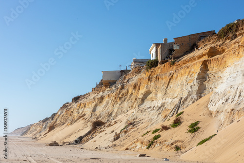 Coastal erosion under houses in Almonte Donana National Park Andalusia Spain. 2 september 2025.