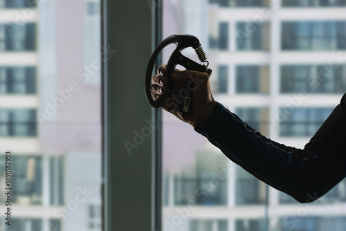 Tableau sur toile Silhouette of male arm doing exercise with expander to strengthen hand muscles