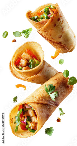 Three golden-brown, crispy, rolled wraps, filled with savory chicken and vegetables, are in mid-air, with scattered toppings