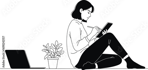 Focused young woman creating digital art on tablet with laptop nearby