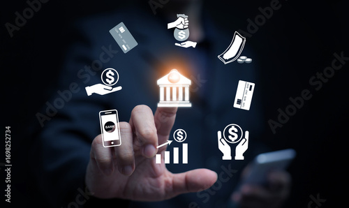 Businessman using digital banking technology with finance icons, mobile payment, credit card, online transaction, and money management in modern financial services.