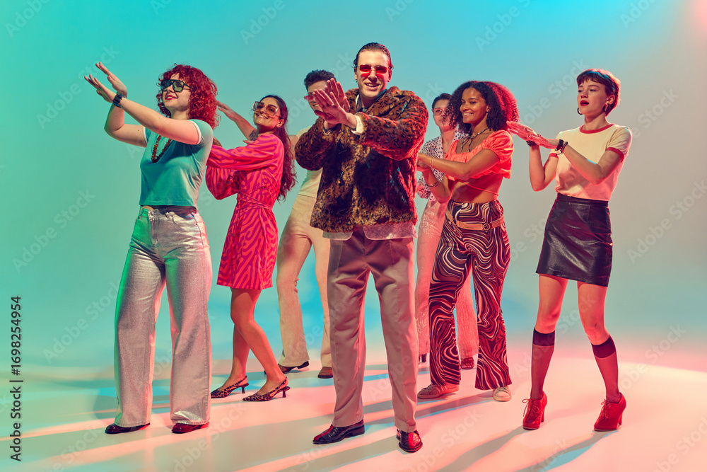 Fototapeta premium Group of stylish dancers performing synchronized disco moves. Concept of teamwork, retro culture, vibrant nightlife, collective fun and music celebration.