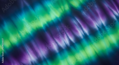Tie dye abstract tiedye pattern with vibrant green, blue, and purple swirls and streaks for commercial usage