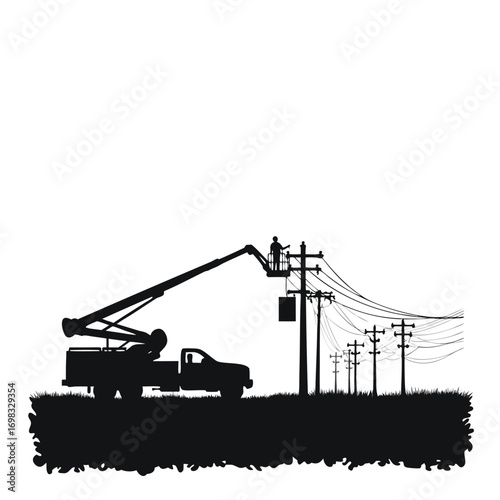 Silhouette of lineman working on power lines from bucket truck