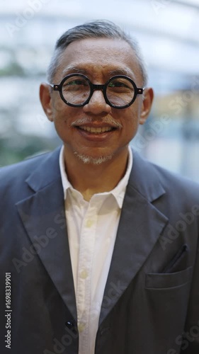 Wallpaper Mural Vertical View. Portrait of the Senior Handsome Grey Haired Man Manager. Matured Businessman Looking at Camera,Smiling in Formal Suit and Glasses. Business and People Concept Torontodigital.ca