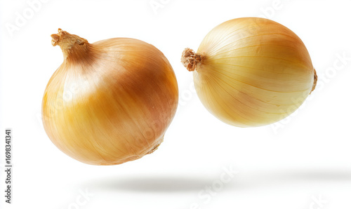 Two fresh yellow onions fall down