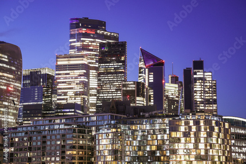 Night View of a Modern Cityscape with Illuminated Skyscrapers and Reflcctions, City of London