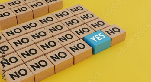 A single blue cube with the word YES stands out amongst many wooden cubes with the word NO