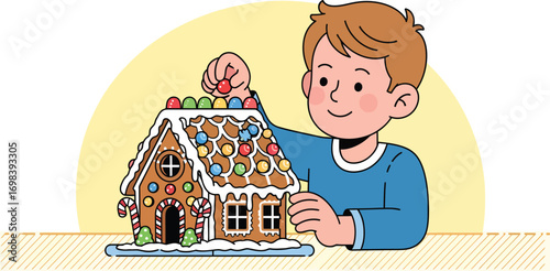 Young boy happily decorating a festive gingerbread house with candy.