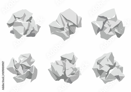 Set of crumpled paper balls in various shades of grey, isolated on a clean white background, representing discarded ideas, errors, or recycled waste.
