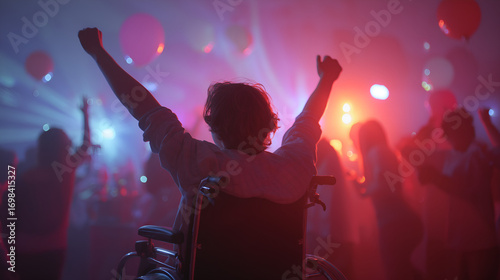 Person in wheelchair celebrates life with arms raised at vibrant party, enjoying music and social event
