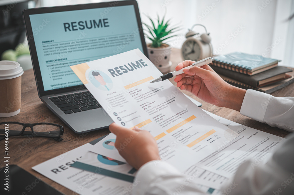 Naklejka premium People are reviewing job applications before filling out their resume on the job application form in order to apply for a job at a company.