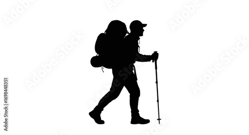 Silhouette of a hiker with a backpack and trekking poles walking
