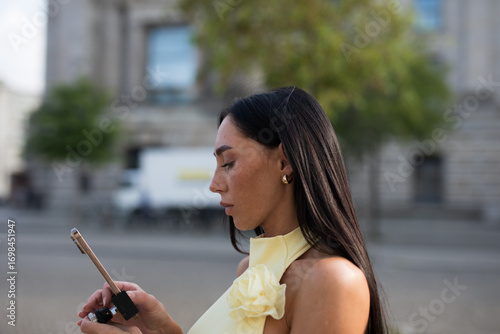 young woman using tablet computer in the city