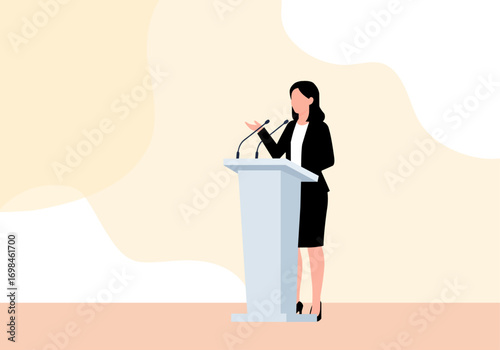 A woman in a black suit stands behind a podium speaking into microphones