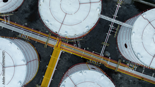 Photos Aerial view white oil storage tank with pipeline steel, Crude oil industry, Storage fuel gas container tank petroleum refinery industrial factory, Oil storage chemical petrochemical refinery product