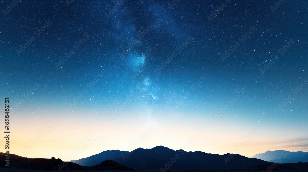 Fototapeta premium Night Sky with Stars and Milky Way: A breathtaking nightscape unfolds, showcasing the majestic Milky Way galaxy streaking across the inky canvas of the heavens above a tranquil mountain range.