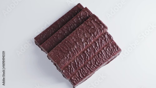A pile of chocolate protein bars close up. Healthy snacks, energy and natural ingredients. Great snack after a long workout. High quality 4k footage