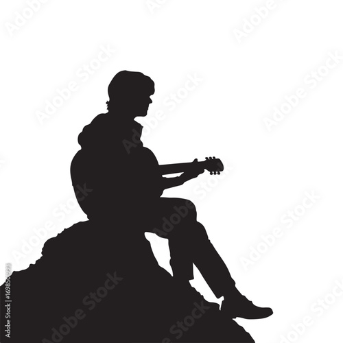 Silhouette of a Man Playing Guitar While Sitting on Rock