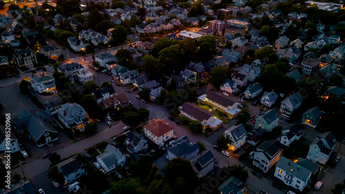 Aerial view of Salem Massachusetts neighborhood on a summer night with pink clouds 