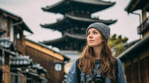 Wallpaper Mural Tourist explores traditional Asian street with temple backdrop. Torontodigital.ca