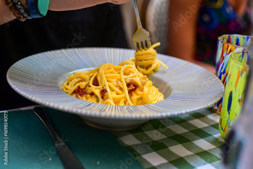 Fresh pasta   spaghetti  carbonara and Aperol Spritz  at  typical italian resaturant at Trastevere   neighbourhood at Rome 