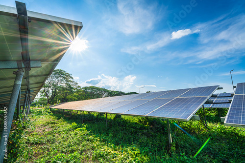 Photovoltaic solar power panel on dramatic sunset blue sky background, green clean Alternative power energy concept.