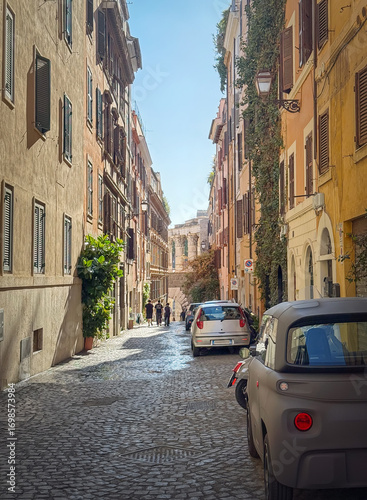 Narrow cobblestone street in Rome is lined with traditional buildings. The walls are adorned with shutters and climbing plants