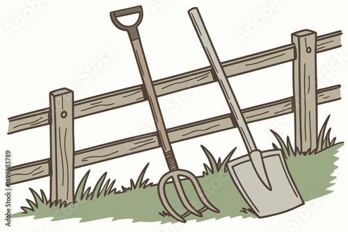 Garden tools leaning against a wooden fence in grass