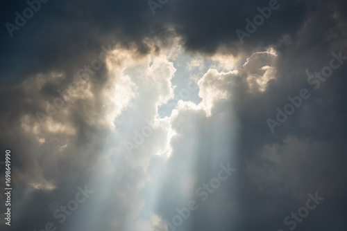 A bright ray of sunshine breaks through dark thunderclouds