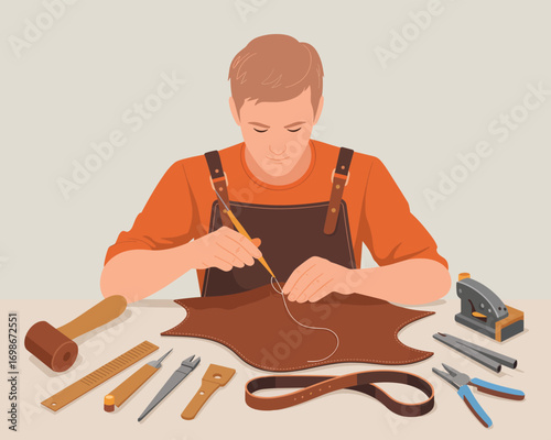 Skilled craftsman in an apron hand-stitching a leather product at a workshop table with tools