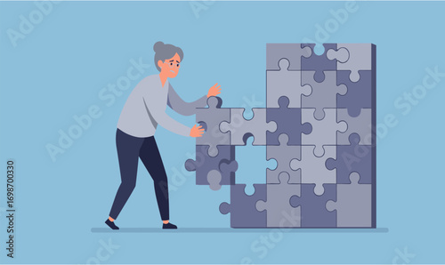 A focused senior woman diligently works to complete a complex jigsaw puzzle, carefully placing the final piece against a serene blue background.