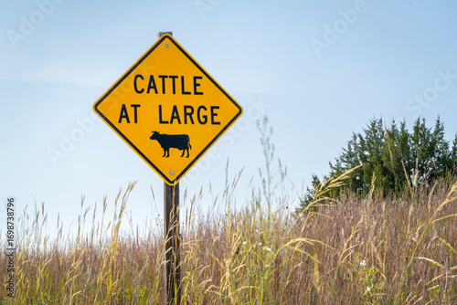 cattle at large - open range warning road sign on a backcountry road in Nebraska Sandhills