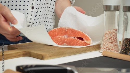 Female hands preparing the trout fish for cooking at home kitchen. Concepts of healthy eating and seafood