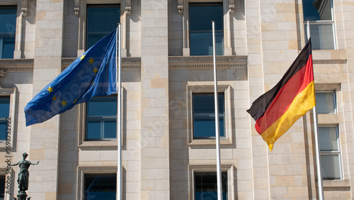 Photograph of the European Union and German flag waving in the breeze