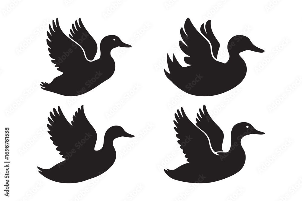 Fototapeta premium Four silhouettes of ducks in flight