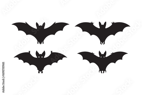Four silhouetted bats flying against a white background