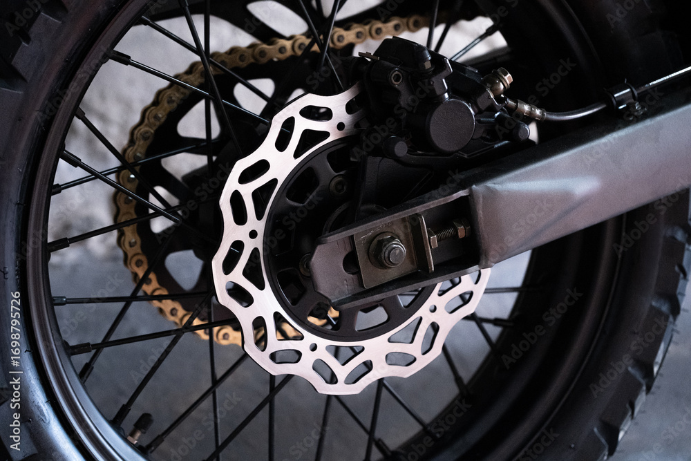 Fototapeta premium Rear wheel motorcycle with chain and disc brake closeup.