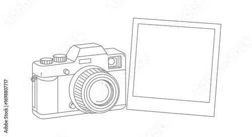 a classic camera beside an empty photo frame