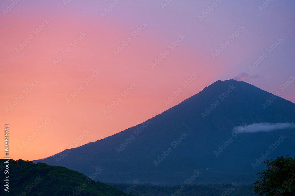 Obraz premium Silhouette of the Agung volcano at sunset. Panorama of the mountain on the island of Bali.